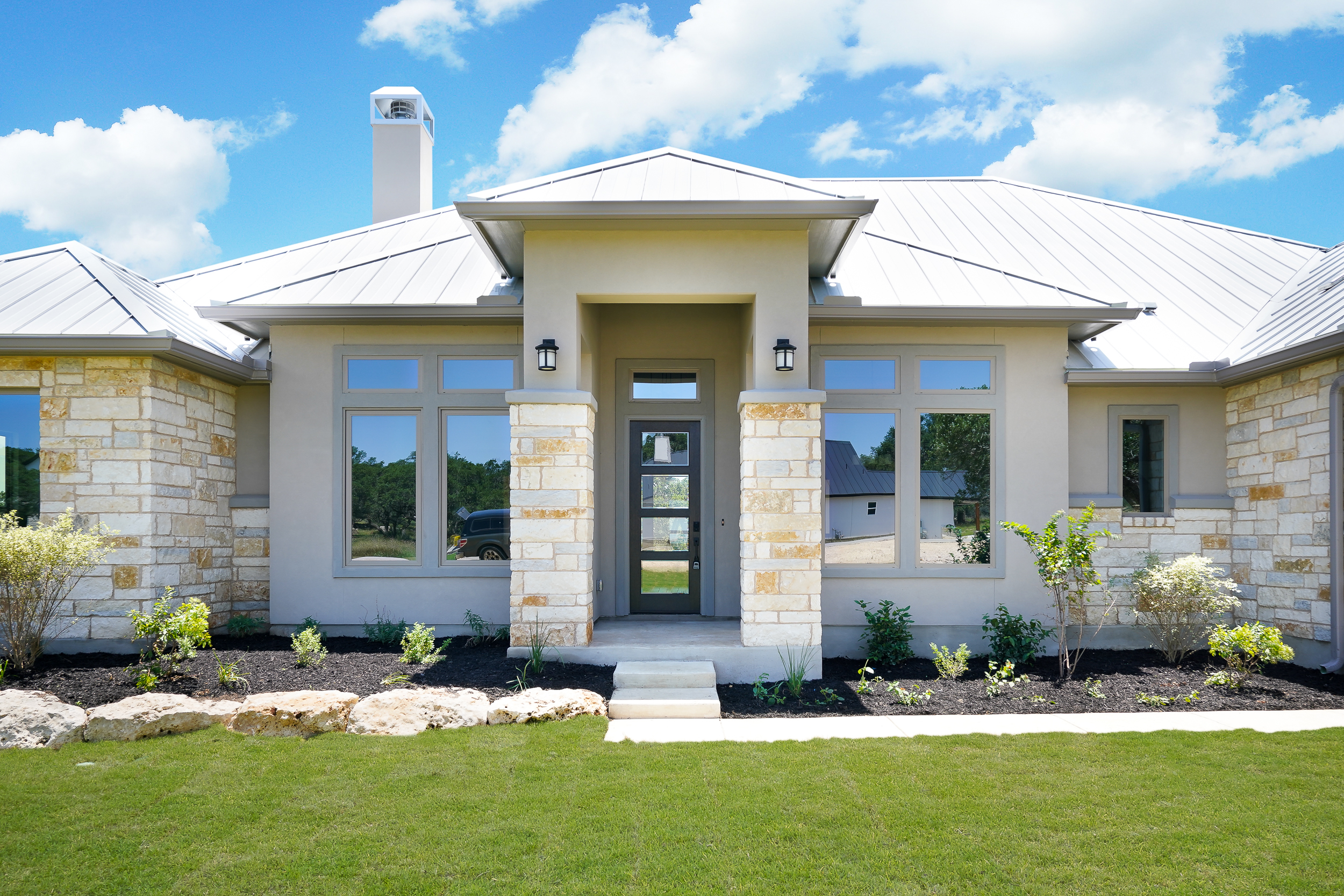 A side view of the front of the Belle Oaks custom home plan from JLP Builders